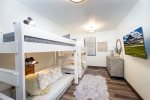 The bunk room offers 3 twin beds & a full-size sleeper sofa.